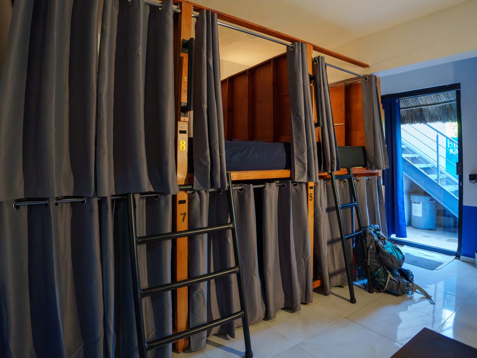 8-bed mixed dorm with wood bunks at Maui Hostels Playa del Carmen