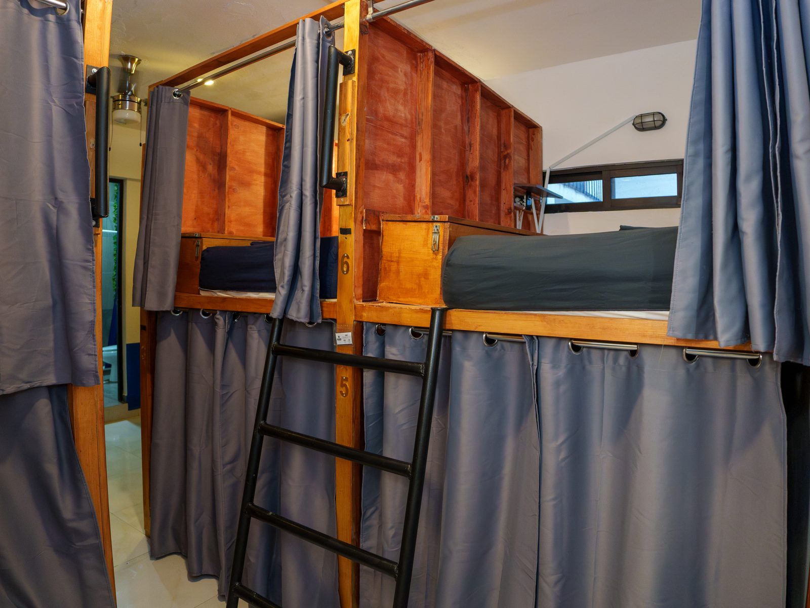 6-bed mixed dorm with curtained bunks at Maui Hostels Playa del Carmen