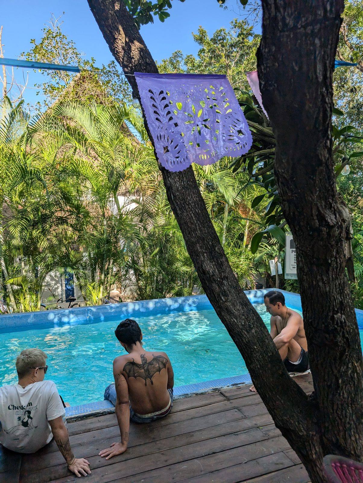 Palapa lounge with macramé and hammock at Maui Hostels Tulum