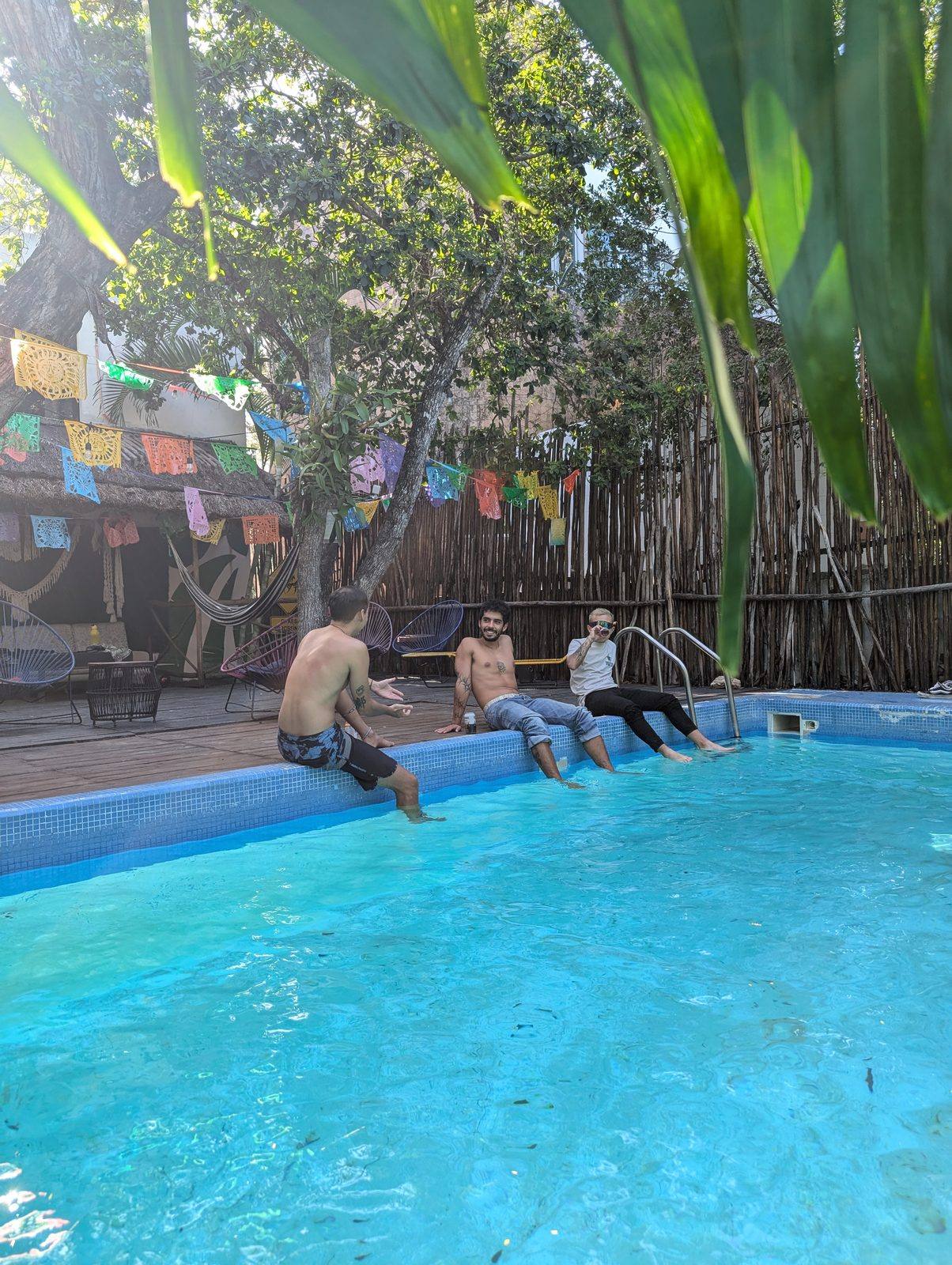 Pool deck and papel picado bunting at Maui Hostels Tulum jungle hostel